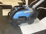 a blue and black machine on a black and white checkered floor