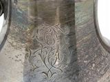 a silver vase that is sitting on a table