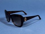 a close up of a pair of sunglasses on a blue surface