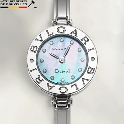 a close up of a watch on a white surface
