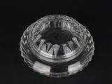 a close up of a clear glass bowl on a black surface