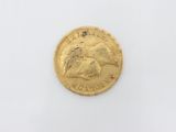 a close up of a gold coin on a white surface