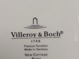 a close up of a white plate with a black and white logo on it