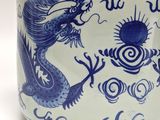 a blue and white vase with a dragon on it