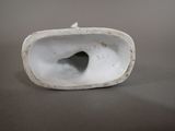 a white porcelain object with a hole in the middle
