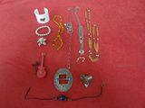 a lot of jewelry that is laying out on a red surface
