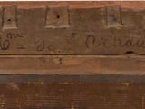 a piece of wood that has writing on it