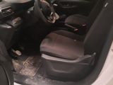 the interior of a car with the door open and the driver ' s seat down