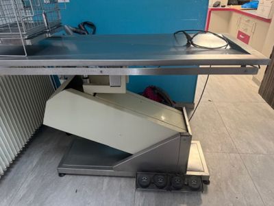 a metal table with a microwave on top of it