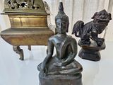 a statue of a person sitting in a lotus position