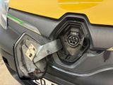 a close up of a car ' s front bumper with a gas pump attached to it