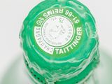 a close up of a bottle of water with a green cap