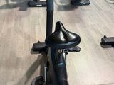 a row of stationary exercise bikes in a gym