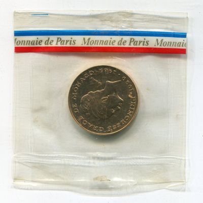 a small coin in a plastic bag on a white surface