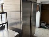 a stainless steel refrigerator in the middle of a kitchen