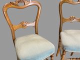 pair of antique chairs with blue upholstered cushions and wood frame