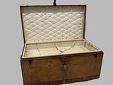 an old suitcase that is open on a gray background