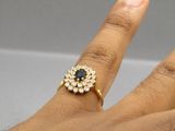 a woman ' s hand with a ring on it