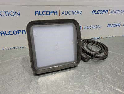 a close up of a light on a table with a cord