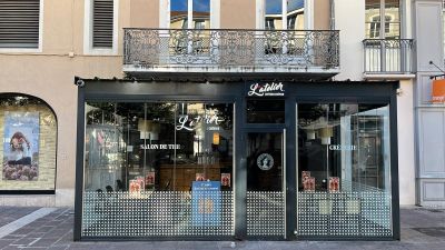 a store front with a sign on the side of the building