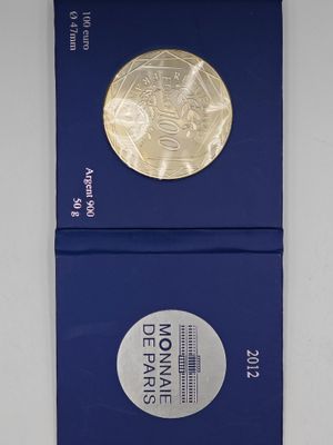 two blue boxes with a gold coin on top of them