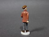 a figurine of a man with a hat and jacket