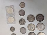some coins are sitting on a white surface with a small amount of them