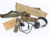 an assortment of military items including a belt, headphones, and a book