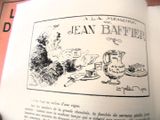un livre ouvert sur lequel figure le dessin d'un homme et d'un chien assis à une table