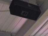 a black suitcase hanging from the ceiling of a building