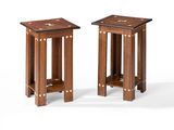 a pair of small wooden tables with a shelf on each side
