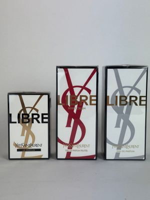 three boxes of yves liberte perfume on a white surface