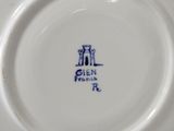 an image of a close up of a white plate with blue writing on it