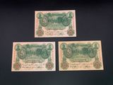three old german bank notes on a black background
