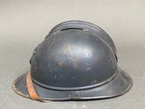 a helmet on the ground with a rope around it