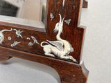 a mirror that has a picture of a bird on it