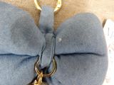 a blue bow tie with a gold keychain attached to it