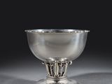an antique silver bowl with a decorative design on a pedestal