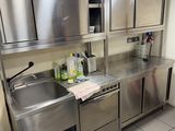 a kitchen with stainless steel cabinets and a sink