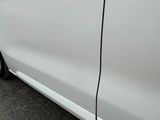 a white car parked in a parking lot next to a parking meter