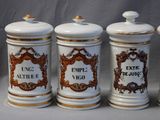 three white and gold kitchen canisters with ornate designs on them