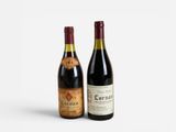 two bottles of wine sitting next to each other on a white surface