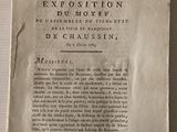 un bout de papier accroché au mur, sur lequel est collé un autre bout de papier