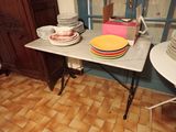 a table with plates and bowls on it in a room