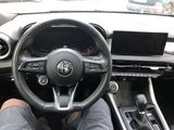 a man sitting in the driver ' s seat of a car