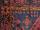 a red and blue rug on a white surface
