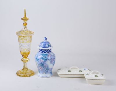 two vases and a bowl sitting next to each other on a table