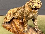 a statue of a dog that is sitting on top of a rock