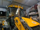 a large yellow tractor parked in a warehouse
