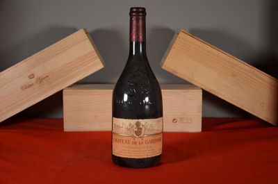 a bottle of wine sitting on a table next to two wooden boxes